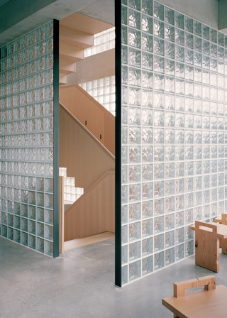 light oak staircase entrance between two full glass block walls