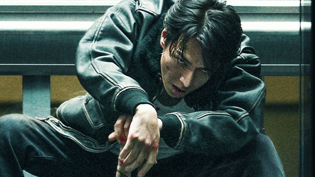 Poster Art for Demon City on Netflix. Shuhei Sakata leaning over with a determined look in his eye and his hands resting between his spread legs. 