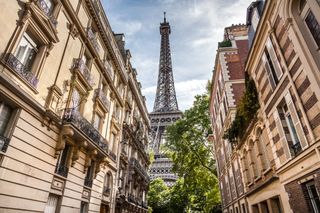 Cityscape of a Paris, best foodie cities in France. A photo of a street showing the Eiffel tower on the horizon