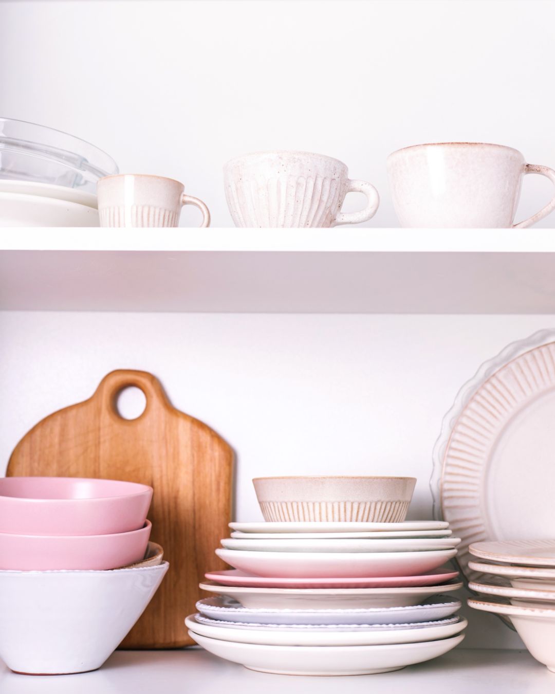 bowls, plates and mugs stored in kitchen cupboard