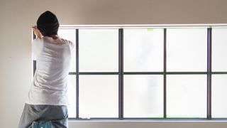 a man about to paint metal windows