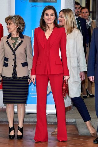 Queen Letizia wearing a red suit