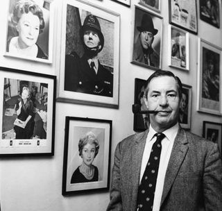 Lord Ted Willis at home, smoking a pipe