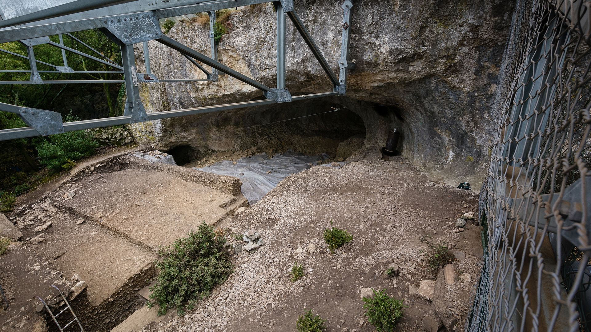 A look at a cave under a bridge.