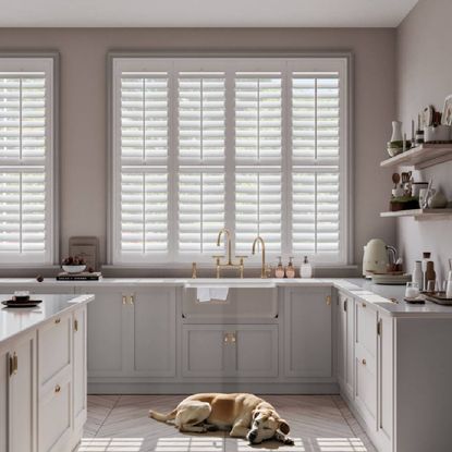 A modern, cream kitchen featuring shutter blinds from Swift Direct Blinds.
