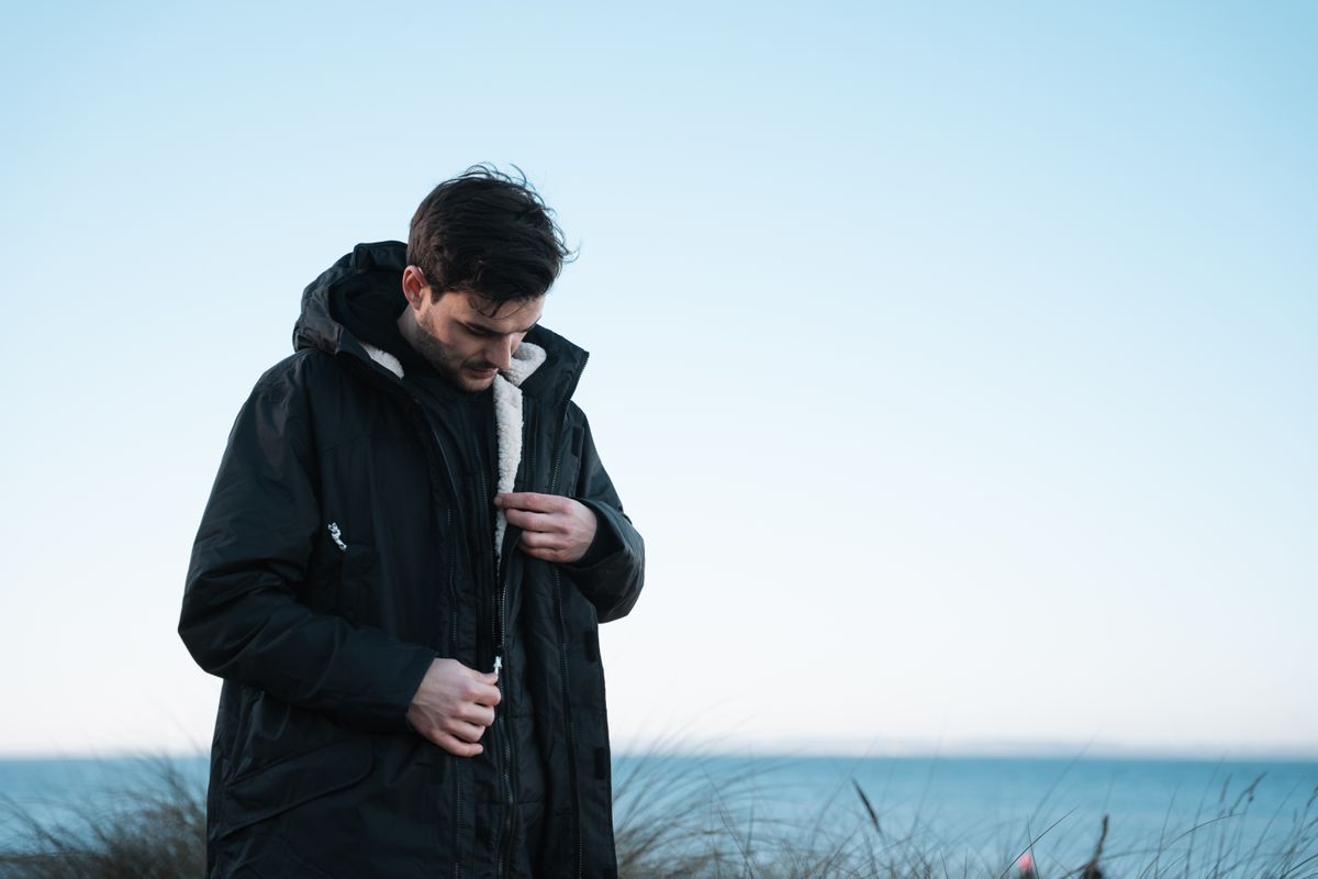 Man wearing the new Voited Wearever jacket at the beach