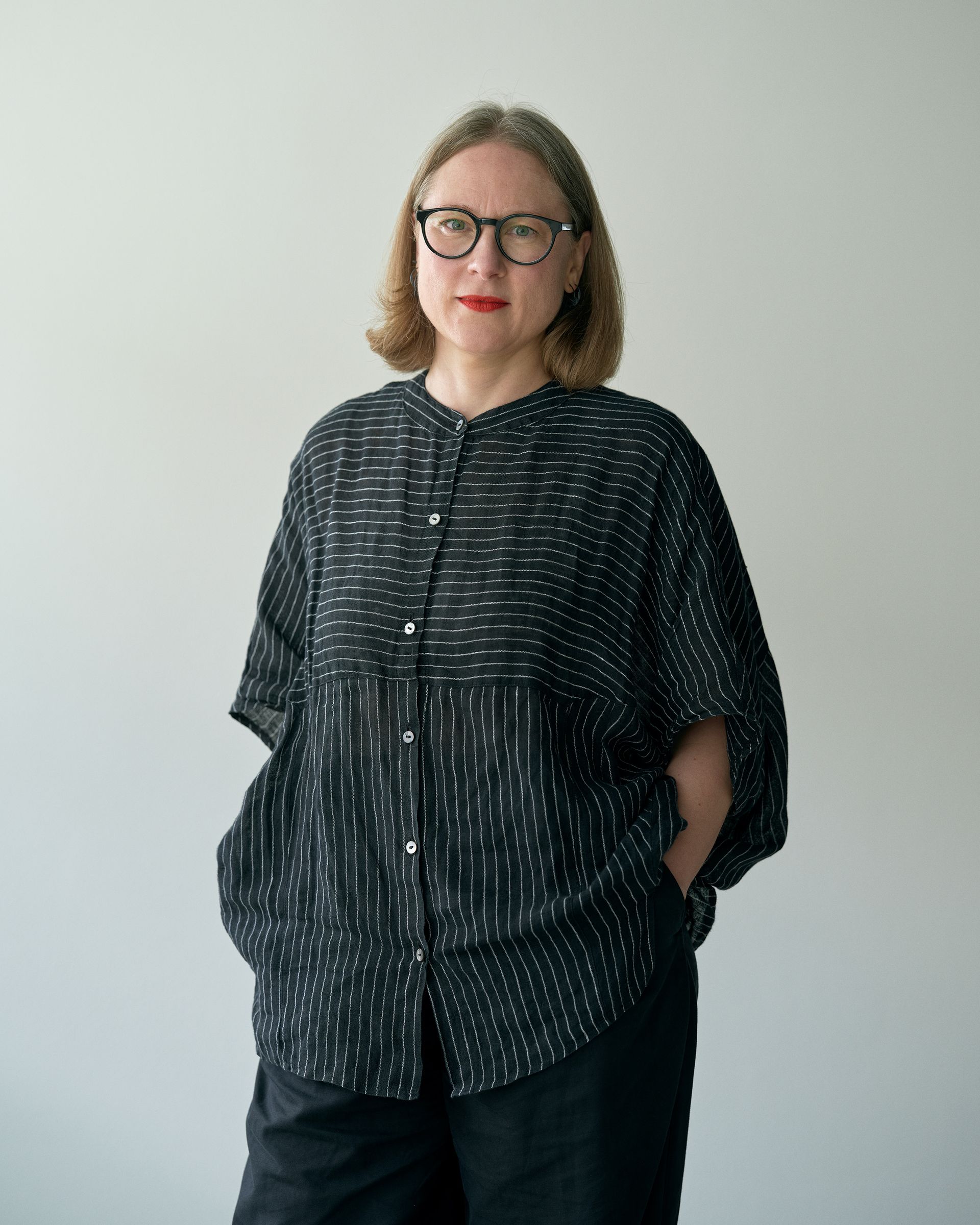 portrait of Marianne Anthonissen standing against white background