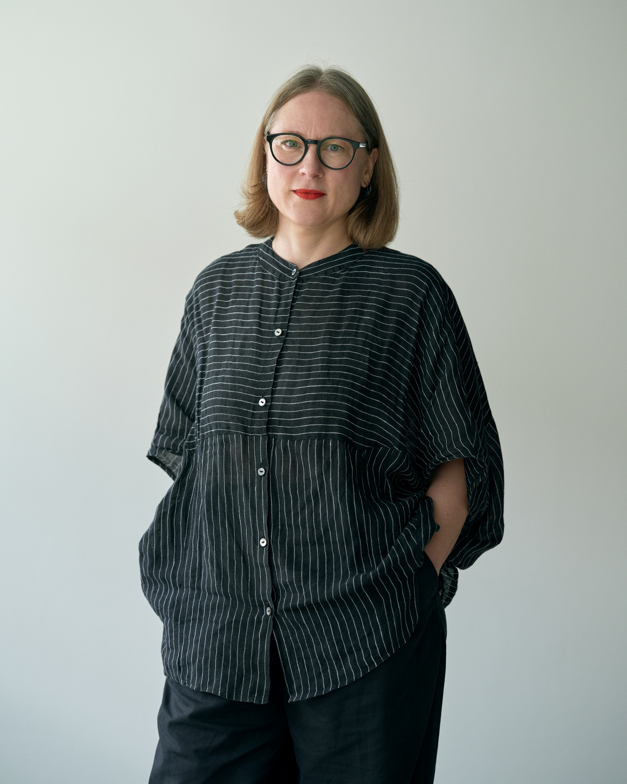 portrait of Marianne Anthonissen standing against white background