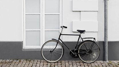 A bicycle in Denmark outside a white brick house