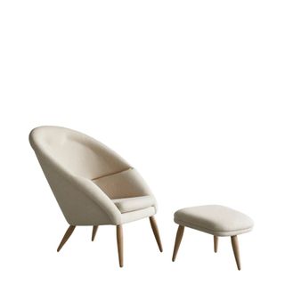 A cream chair with foot rest