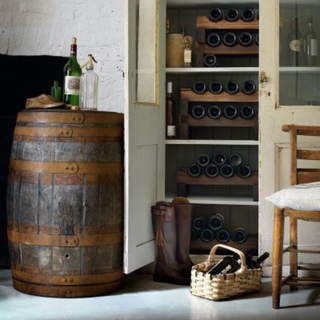 Wine rack next to barrel and chair
