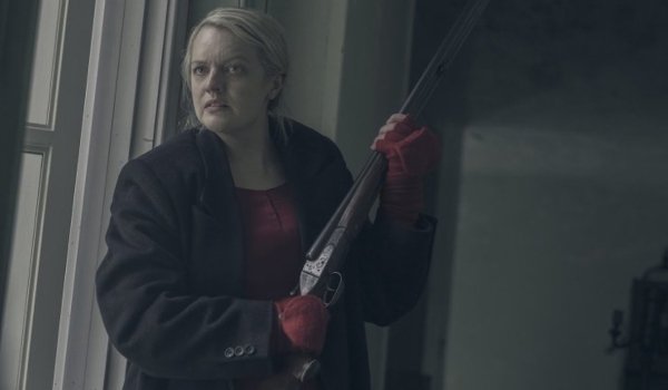 The Handmaid&#039;s Tale Elizabeth Moss holding a shotgun with a stressed look