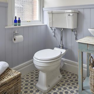 bathrom with printed tiled flooring and white window