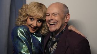 Wendi McLendon-Covey and Rob Corddry smiling together in The Goldbergs season 10