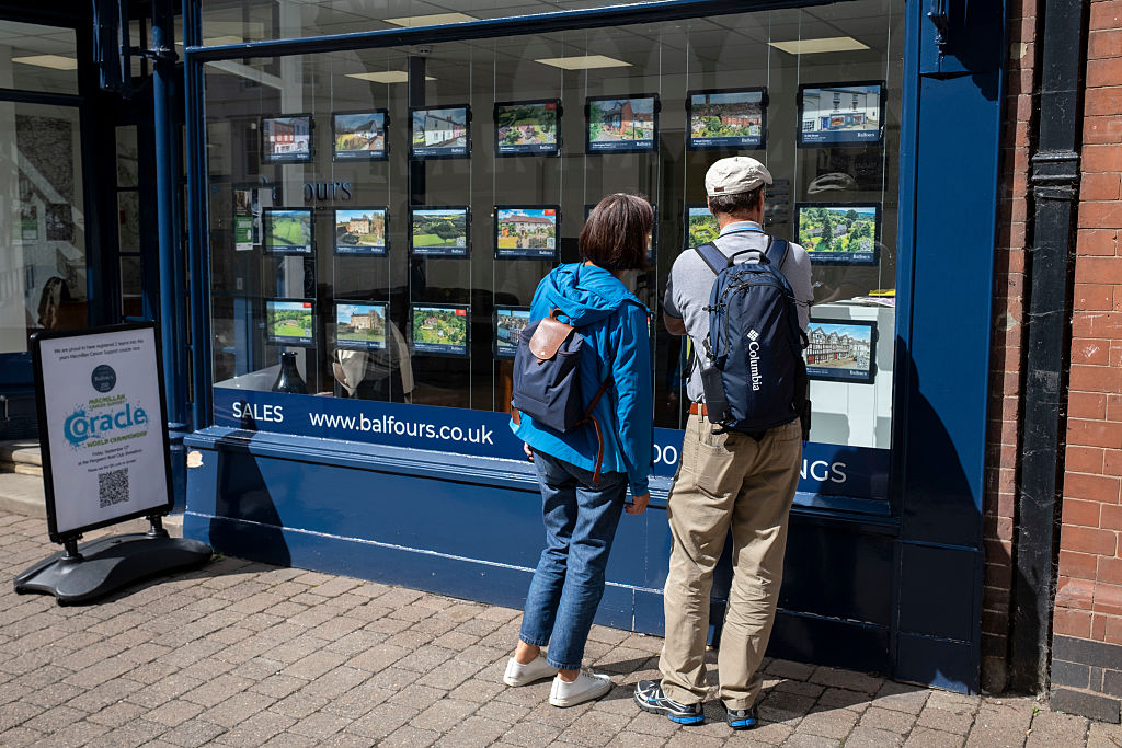 People looking into the window of an estate agent on 27th August 2025 in Bucknell, United Kingdom. Higher UK inflation could have an impact on mortgage rates.