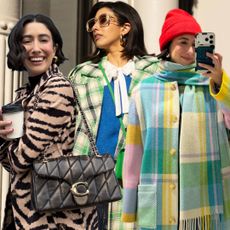 April Lockhart wearing various colorful statement coats