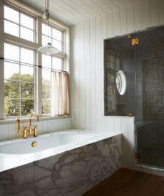 marble bath in a light white bathroom