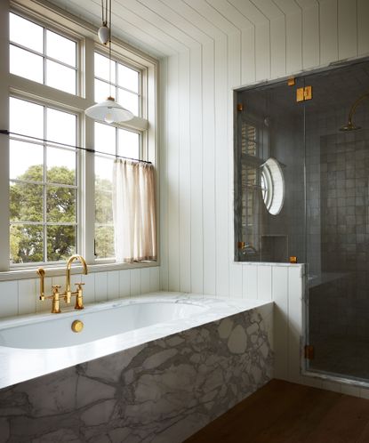 marble bath in a light white bathroom