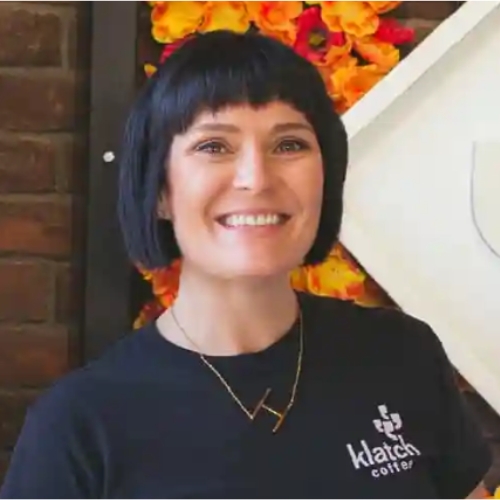 Image of a woman wearing a black t-shirt.
