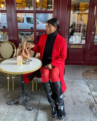 a woman sitting outside a cafe with an updo