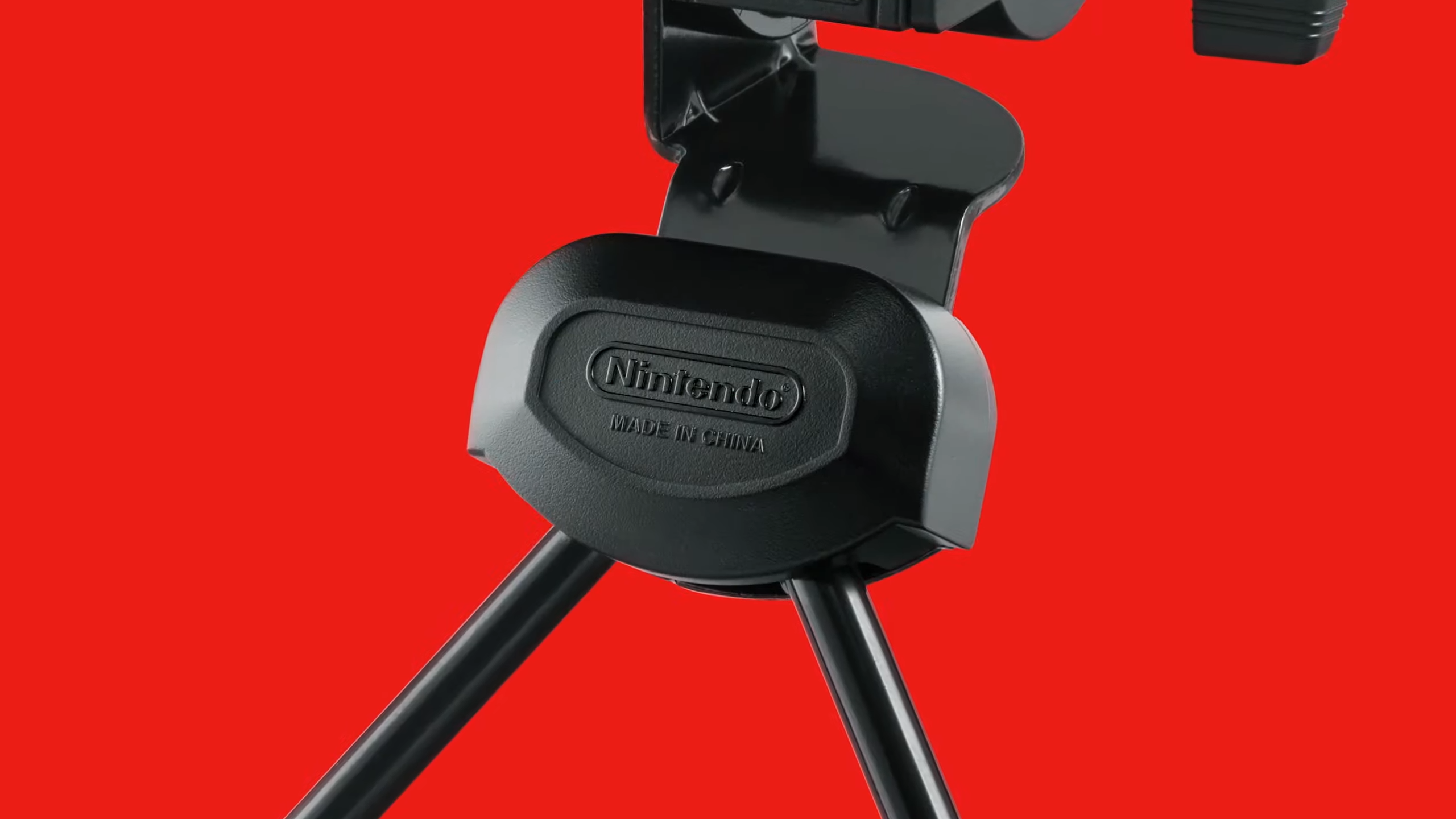 Close up of Nintendo logo on Virtual Boy tripod with red backdrop.