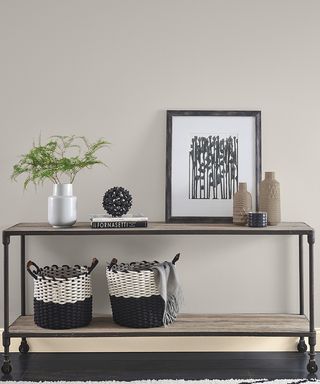 Gray painted living room space with black unit and storage