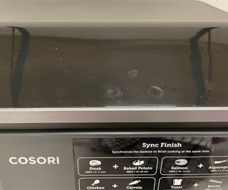 Cosori Dual Drawer Air Fryer touchscreen controls with fingerprints on show