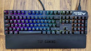 A full view of the Asus TUF Gaming K3 keyboard with RGB lighting on