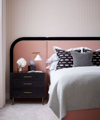 Close up of bed and pink headboard