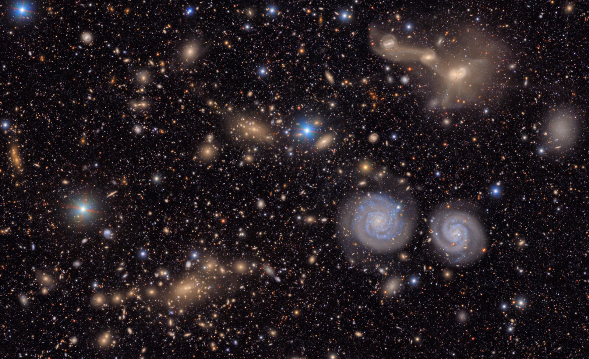 Blue swirls orange and white orbs against a black background