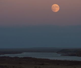 The nearly full supermoon Beaver Moon rises over the Syr Darya river near the Baikonur Cosmodrome spaceport in Kazakhstan on Nov. 13, 2016 in this view by NASA photographer Bill Ingalls.