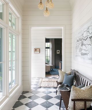 Hallway with chequerboard floors and horizontally paneled walls