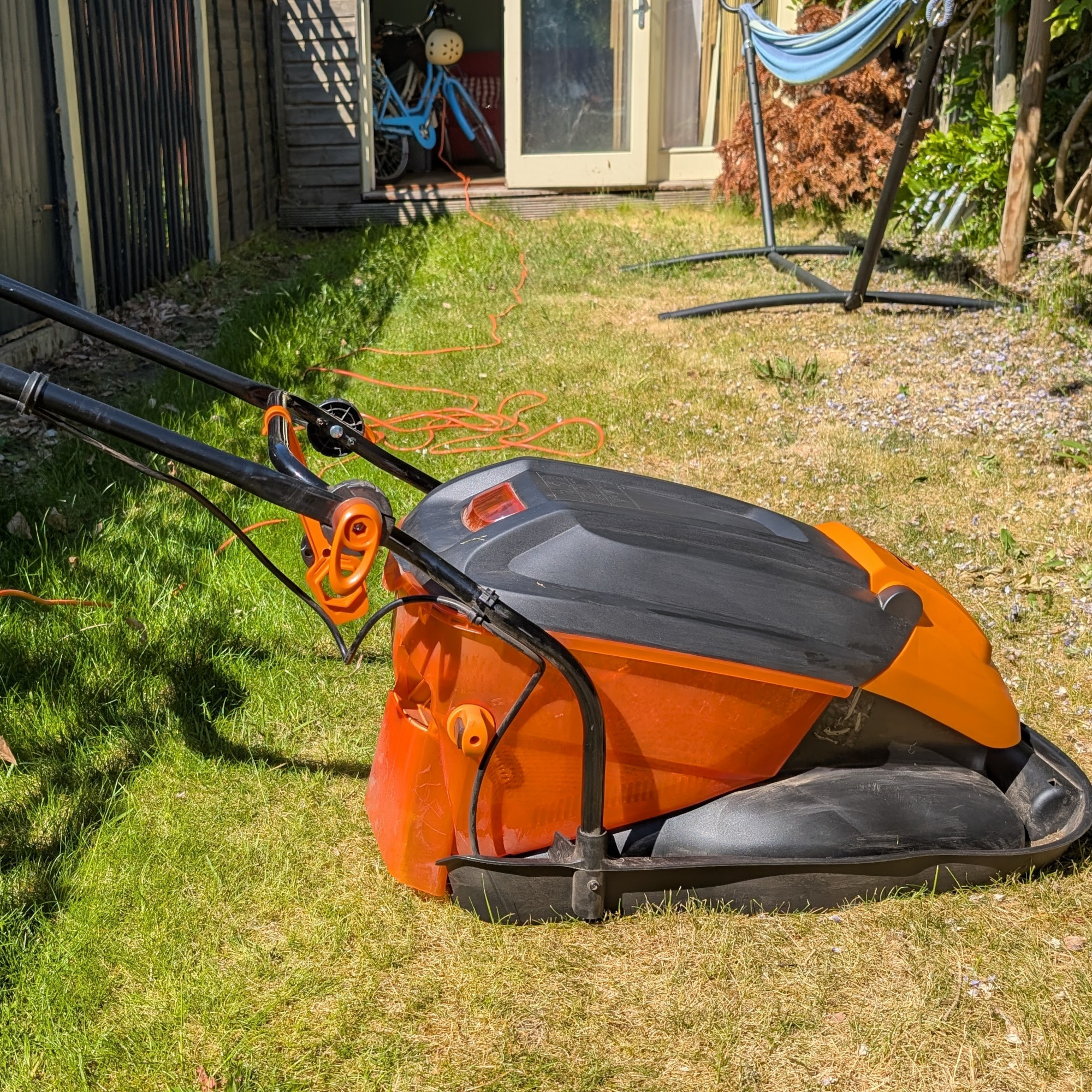 LawnMaster 1800W Electric Hover Lawn Mower on a small lawn