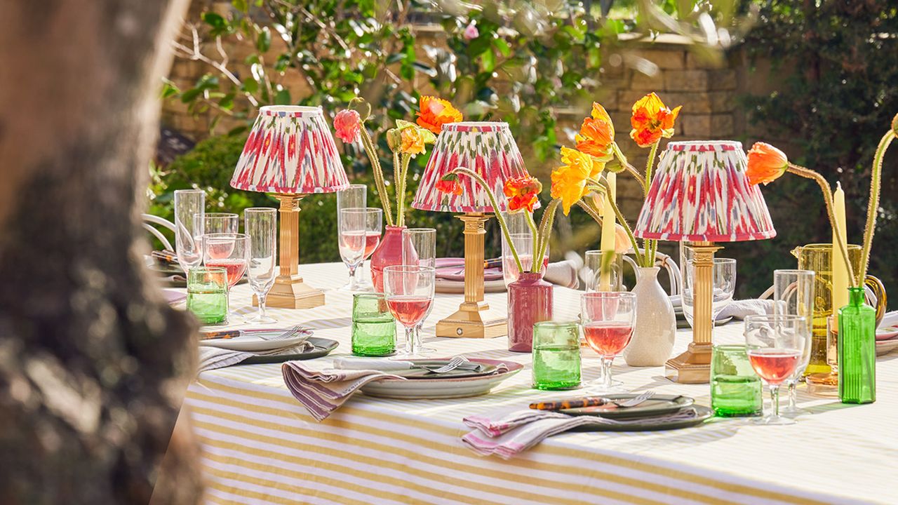 Colourful table lamps on dining table in garden