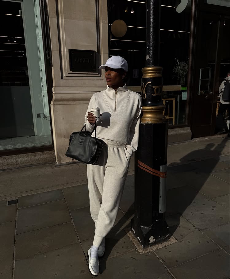 @nlmarilyn wears a knitted trouser and jumper set with loafers and a baseball cap