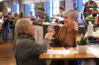 two women cheersing glasses of champagne at woman&home christmas live