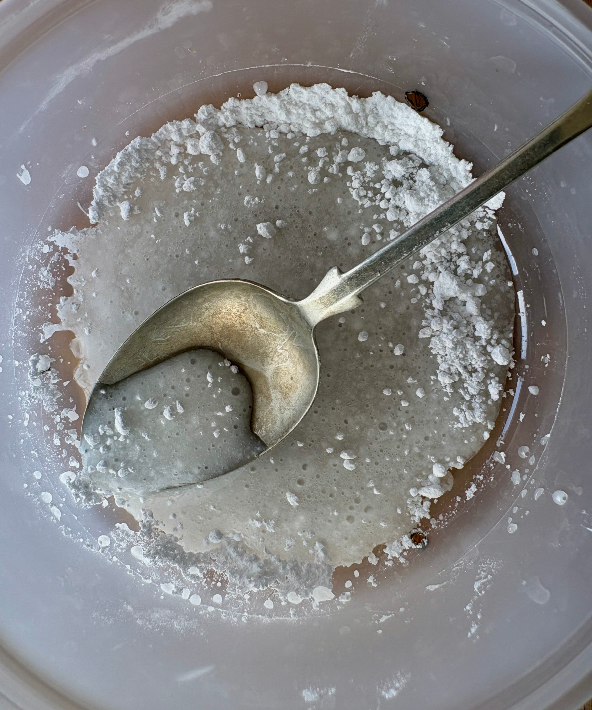 adding water to a homemade ant trap
