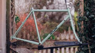 A green steel bike frame with downtube shifters