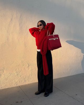 Aimee Song wearing a red sweater