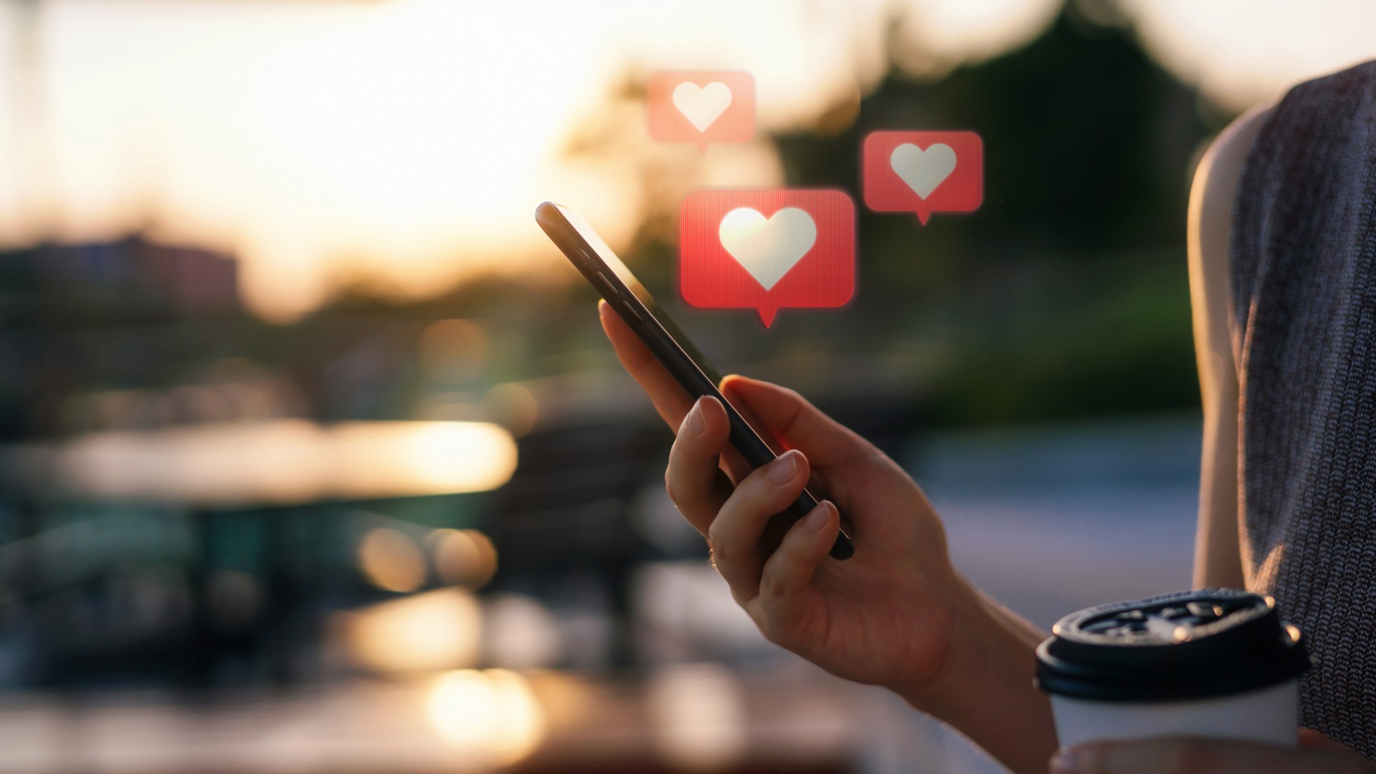 woman on phone with love hearts coming out of the screen