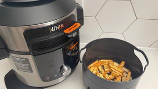 The Ninja Foodi 15-in-1 SmartLid Multi-Cooker having be used to air fry chips