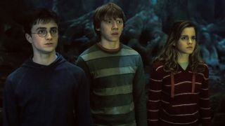 Daniel Radcliffe, Rupert Grint, and Emma Watson stand stunned in the Forbidden Forest in Harry Potter and the Order of the Phoenix.