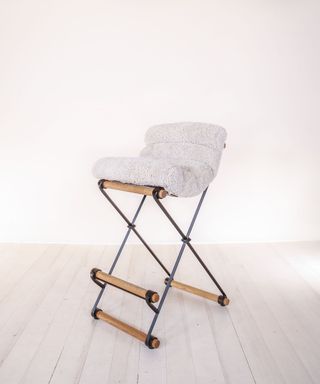 Thomas Hayes Studio folding metal counter stool with rolled wooden feet and off-white shearling seat