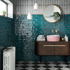 bathroom with tiles wall and round mirror