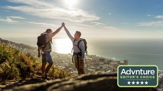 Two hikers celebrating on top of a hill