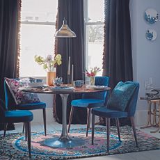 dining room with round table and blue chairs