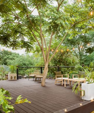 composite decking design with garden furniture and fairy lights