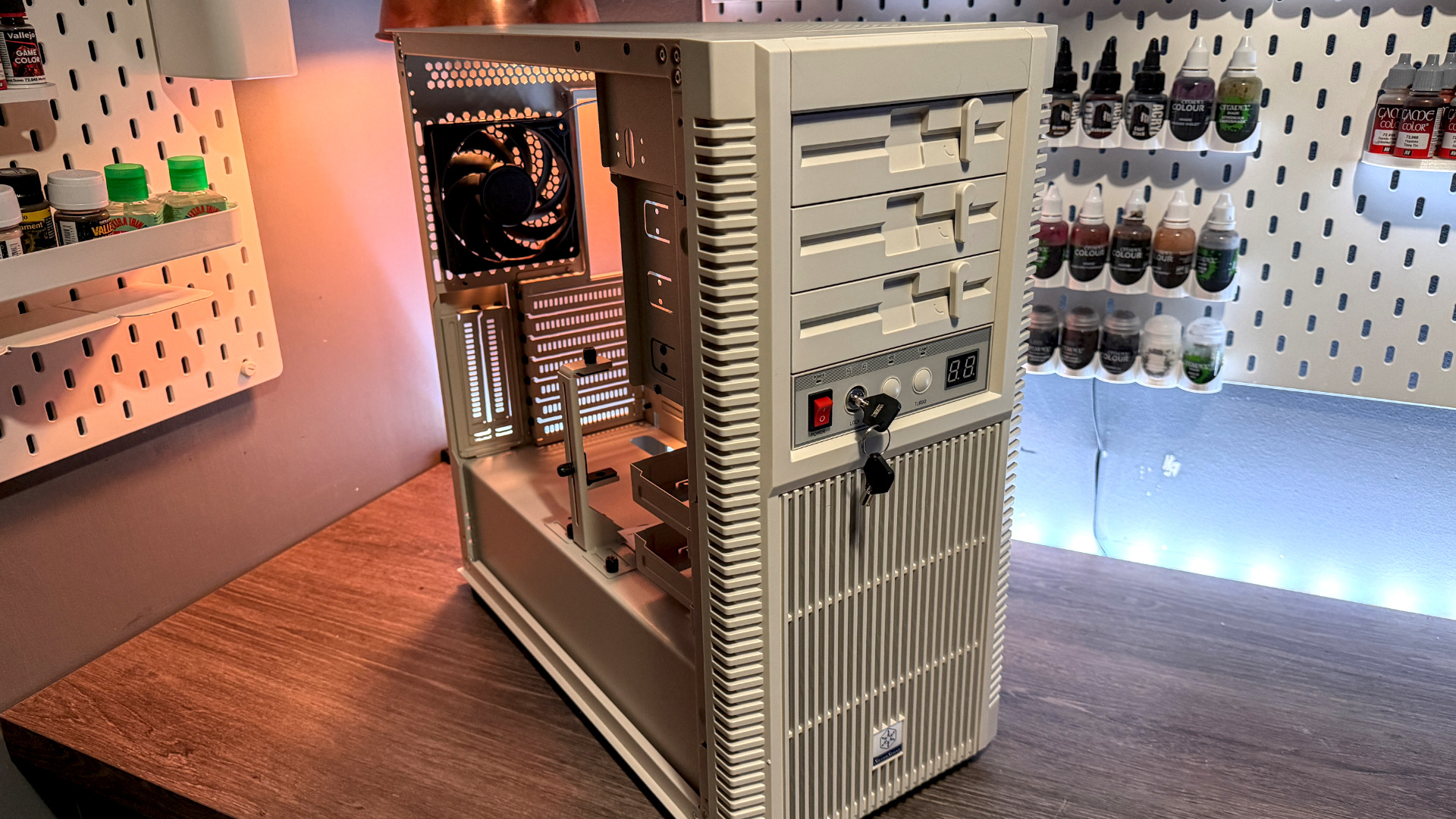 The retro-styled Silverstone FLP02 PC case as a PC is being built into it on a desk.