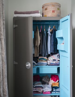 A wardrobe with painted blue interior