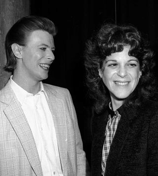 David Bowie and Gilda Radner laughing at a party
